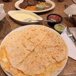 Chicken Quesadilla, queso in background Chicken Quesadilla, queso in background