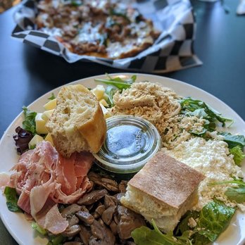 D'Avolio Kitchen - Antipasto salad with arugula, Swiss and goat cheese, mushrooms, prosciutto, Italian herb chicken, and basil pesto. - Italian Near Me - Williamsville, New York