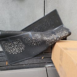 FedEx Office Print & Ship Center - Our welcome mat pushed against the packages to keep them from blowing away I guess? No other explanation for this mess.