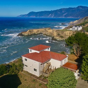 Cliff House - Drone view of Cliff House, a Hotel in Shelter Cove, CA. King Range Mountains and Lost Coats Trail in the background. - Hotels Near Me - Whitethorn, California Cliff House - Drone view of Cliff House, a Hotel in Shelter Cove, CA. King Range Mountains and Lost Coats Trail in the background. - Hotels Near Me - Whitethorn, California