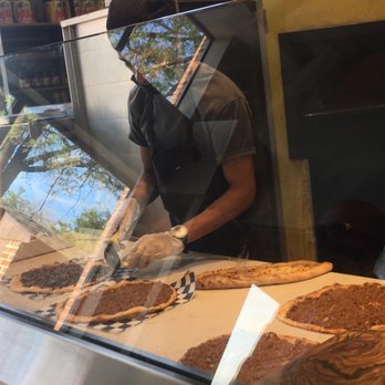 The Block - Slicing pizzas with mask down - Mediterranean Near Me - Vienna, Virginia