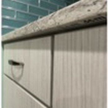 Arkansas Construction And Remodeling - counter end with 1" overlap. No overlap on the other end.  Not square with cabinets. - Roofing Near Me