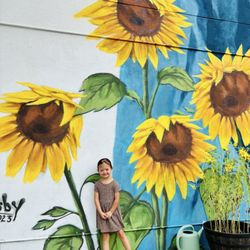 Lula Mae Bistro - My granddaughter Aurora posing in front of mural on the side of Lula Mae's Bistro before our lunch.