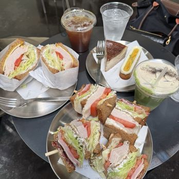 The Cakery Cafe - Bottom: Signature Club sandwich ($14.50) which came with turkey, ham, bacon, cheese, lettuce, and tomato on wheat bread. - Sandwiches Near Me - San Diego, California The Cakery Cafe - Bottom: Signature Club sandwich ($14.50) which came with turkey, ham, bacon, cheese, lettuce, and tomato on wheat bread. - Sandwiches Near Me - San Diego, California