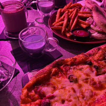 Le Jardin - a pizza and french fries on a table - Hookah Bars Near Me - Falls Church, Virginia
