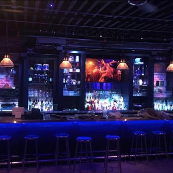Pier 132 - a bar with blue lighting and bar stools - Venues & Event Spaces Near Me - Bronx, New York