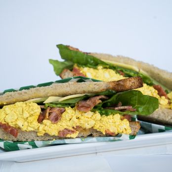 Glowing - Breakfast Sandwich: Tofu scramble, vegan bacon, vegan cheese, seasonal greens, tomato, and vegan mayo on crispy toast bread - Health Markets Near Me - Los Angeles, California