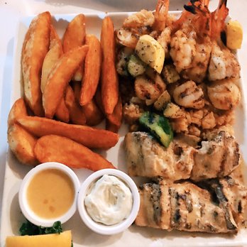 Gaido's - The combination platter (charcoal-grilled Gulf shrimp, deep sea scallops, and Mahi Mahi) with fried sweet potato - Seafood Near Me - Galveston, Texas