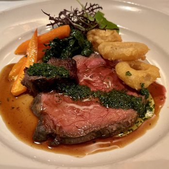 Chez Panisse - Rib eye with onion rings, sautéed kale, and roasted carrots - New American Near Me - Berkeley, California