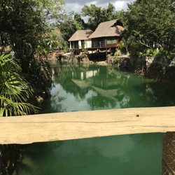 Hotel Zamna - Crossing one of the bridges over the cenote that goes fully around the island where they hold the party.