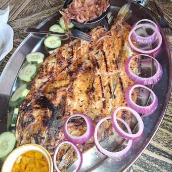 ConiSeafood - Pescado zarandeado: whole grilled snook fish with garnishments of red onions, fresh sliced cucumbers, carmalized grilled onions. - Mexican Near Me - Inglewood, California