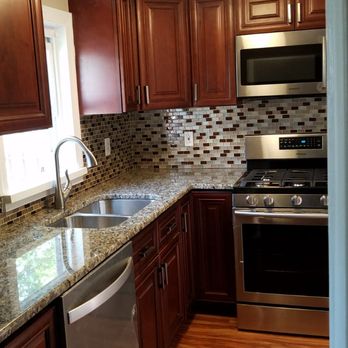 Bangs Construction - a kitchen with wood cabinets and stainless steel appliances - General Contractors Near Me Bangs Construction - a kitchen with wood cabinets and stainless steel appliances - General Contractors Near Me