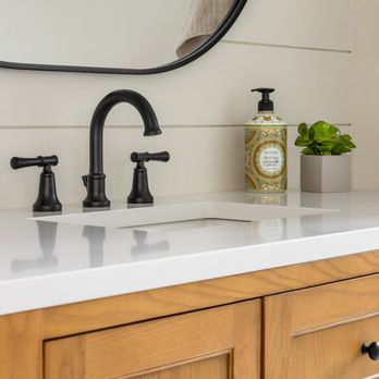 Stonebrook Construction Group - Close-up of wood vanity with matte black faucet and shiplap accent wall. - General Contractors Near Me Stonebrook Construction Group - Close-up of wood vanity with matte black faucet and shiplap accent wall. - General Contractors Near Me