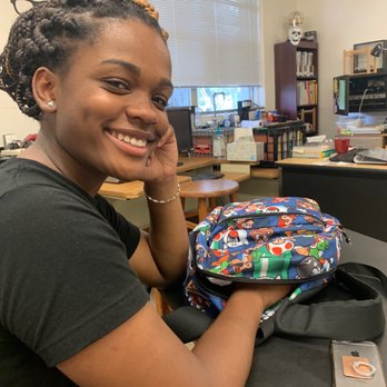 Alaysias Candy Service - a smiling woman with a school bag - Candy Stores Near Me - Lakeland, Florida Alaysias Candy Service - a smiling woman with a school bag - Candy Stores Near Me - Lakeland, Florida
