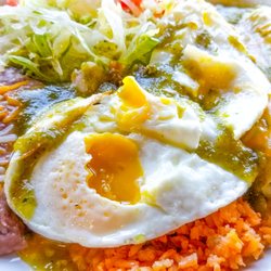 Irma's Cafe - Green Enchiladas with extra eggs on top. Very good!