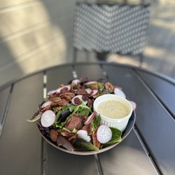 The Local Café - The Local Salad- Organic spring mix, savory bacon, thin sliced radish, maple candied pecans and TLC's house made herb vinaigrette dressing.