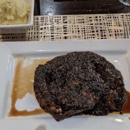 a steak on a plate with a side of mashed potatoes a steak on a plate with a side of mashed potatoes