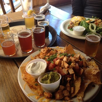 Bend Brewing Company - Beer sampler with a side of nachos. - Breweries Near Me - Bend, Oregon