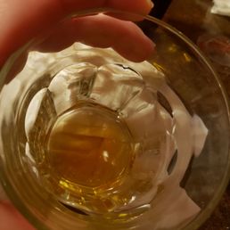 a person holding a glass of beer a person holding a glass of beer