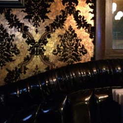 Love the black pleather Booths with velvet wallpaper.