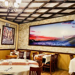 a dining room with a painting on the wall
