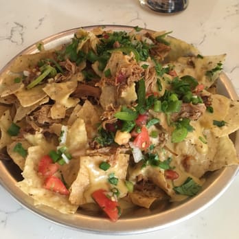 Creston Brewery - Pork nachos with a fresh cilantro garnish - Breweries Near Me - Grand Rapids, Michigan Creston Brewery - Pork nachos with a fresh cilantro garnish - Breweries Near Me - Grand Rapids, Michigan