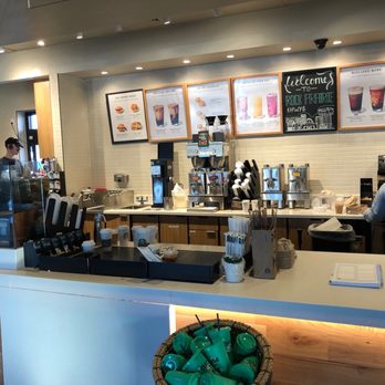 Starbucks - a man standing in front of a counter - Coffee & Tea Near Me - College Station, Texas Starbucks - a man standing in front of a counter - Coffee & Tea Near Me - College Station, Texas