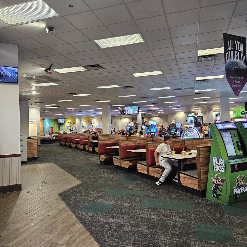 Chuck E. Cheese - a man sitting at a table in a restaurant - Pizza Near Me - Miami, Florida Chuck E. Cheese - a man sitting at a table in a restaurant - Pizza Near Me - Miami, Florida