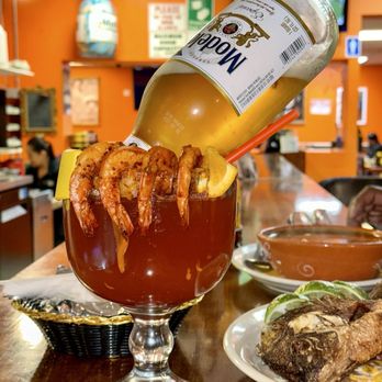 Los Potrillos Taqueria - a person pouring a drink into a glass - Mexican Near Me - Reno, Nevada