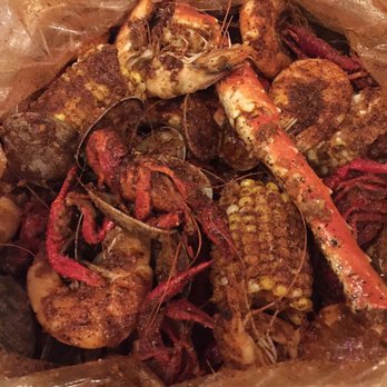 Madison Crab House - King crab legs, clams, shrimp, crawfish, and corn with all sauces except the curry one mixed together - Cajun/Creole Near Me - Chicago, Illinois Madison Crab House - King crab legs, clams, shrimp, crawfish, and corn with all sauces except the curry one mixed together - Cajun/Creole Near Me - Chicago, Illinois