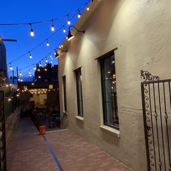 Bruz Off Fax - a sidewalk with lights strung from it - Breweries Near Me - Denver, Colorado