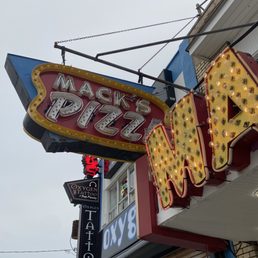 the neon sign for mack's pizza the neon sign for mack's pizza