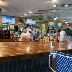 The Reef Bar and Grill - At door to outside seating with bat and inside seating in the foreground.