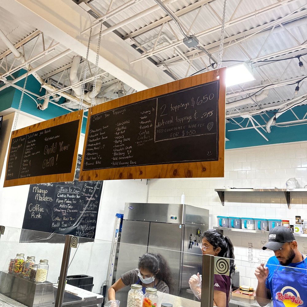 a man and a woman behind a counter a man and a woman behind a counter