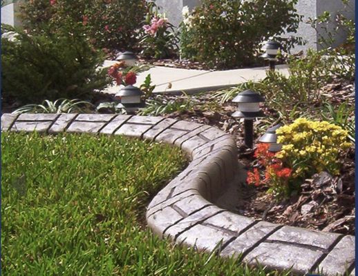 Concrete curbs! - Homeowners can choose from a variety of options, including colored and stamped concrete that mimics brick or stone—adding a decorative touch without the high cost. Durable, low-maintenance, and affordable, decorative concrete curbs are a smart way to enhance the look and structure of any yard or driveway.