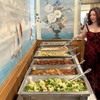 The Barge - a woman serving food at a buffet - Seafood Near Me - Perth Amboy, New Jersey The Barge - a woman serving food at a buffet - Seafood Near Me - Perth Amboy, New Jersey