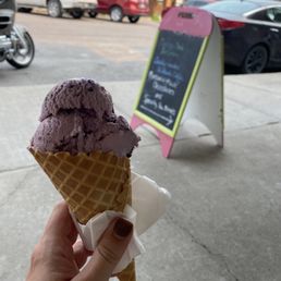 Enjoying the Huckleberry ice cream in a waffle cone in the outdoor seating at Sugar and Spice