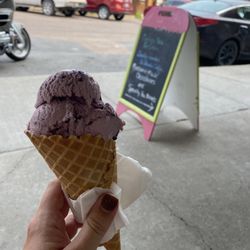 Sugar & Spice - Enjoying the Huckleberry ice cream in a waffle cone in the outdoor seating at Sugar and Spice