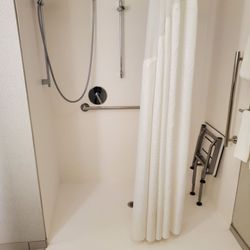 Holiday Inn Express & Suites Milwaukee - Brookfield - Shower slopes downward to the rest of the bathroom so water gets everywhere. It should slope down towards the tub to avoid this.