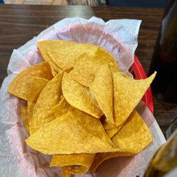 a bowl of tortillas and a bottle of soda a bowl of tortillas and a bottle of soda