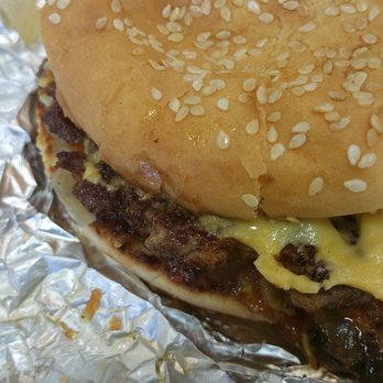 Five Guys - My bacon cheeseburger! I took a bite already so this is the other half of it. - Burgers Near Me - Naperville, Illinois