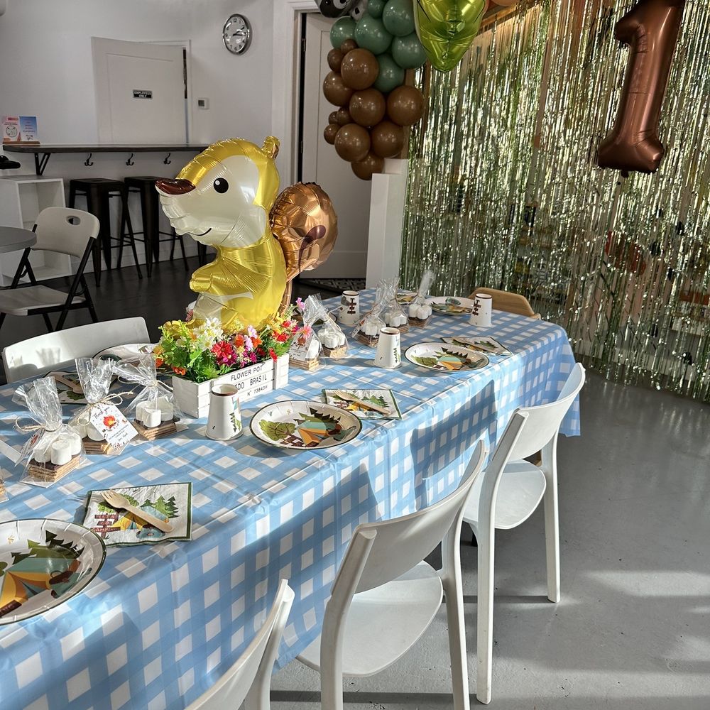 Tumble Haus - a table with plates of food and balloons - Social Clubs Near Me - Denver, Colorado Tumble Haus - a table with plates of food and balloons - Social Clubs Near Me - Denver, Colorado