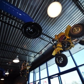 Derry Cycle - A Tri Z and an RZ350 hanging from the entrance - Motorcycle Dealers Near Me - Derry, New Hampshire
