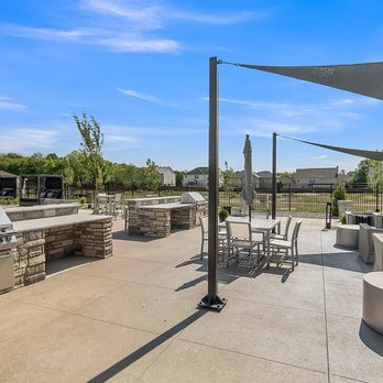 Slate at Fishers District - An outdoor patio with a grill and tables and chairs - Apartments Near Me - Fishers, Indiana Slate at Fishers District - An outdoor patio with a grill and tables and chairs - Apartments Near Me - Fishers, Indiana