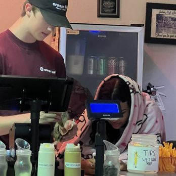 Orange Leaf Frozen Yogurt - Staff at the register with a blanket wrapped around her while the tables are dirty and  no toilet paper in the bathroom. - Ice Cream & Frozen Yogurt Near Me - Baytown, Texas