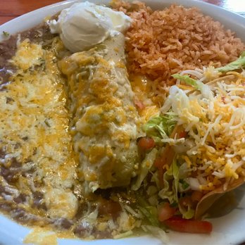 Avila's El Ranchito - Combination plate: crispy shredded beef taco and shredded chicken enchilada with green  tomatillo sauce and sour cream - Mexican Near Me - Laguna Niguel, California