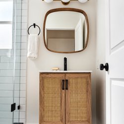 Royal Restoration Santa Barbara - Bathroom remodeling in Santa Barbara by Royal Restoration. Natural wood vanity, brass lighting, and matte black fixtures.
Call today