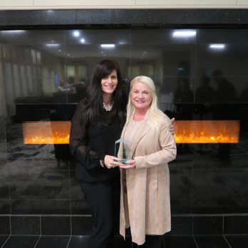 Weed Man - two women standing in front of a fireplace - Pest Control Near Me - Burlington, Ontario