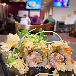 Sushi Kakogan - June 2023 Roll of the Month: Dracula Roll = California roll with tempura flakes & shrimp. Can't taste avocado or salmon. Grassy microgreens.