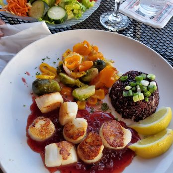 Finn's Fish House - Dinner salad and seared scallops with lingonberry sauce and coconut ginger rice. - Seafood Near Me - Seaside, Oregon Finn's Fish House - Dinner salad and seared scallops with lingonberry sauce and coconut ginger rice. - Seafood Near Me - Seaside, Oregon